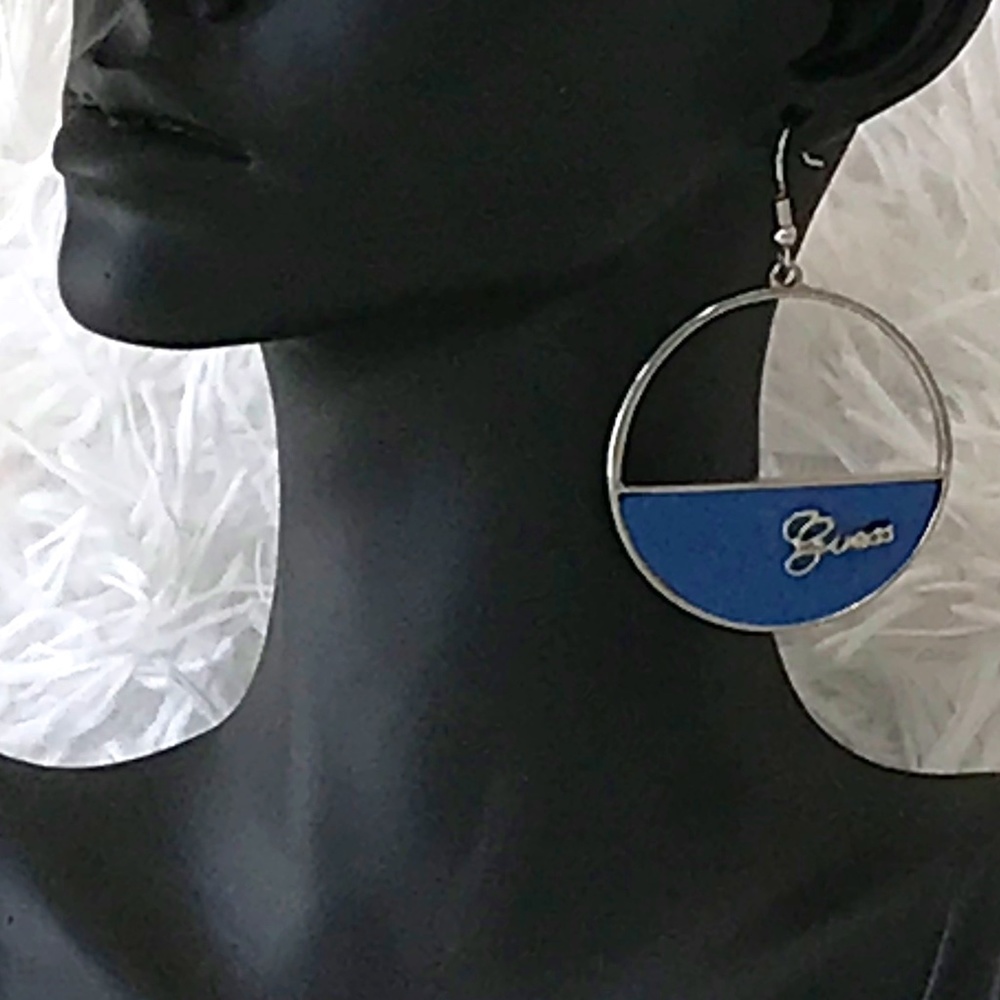 NWT Guess Silver Tone Hoop Earrings With Silver Cursive Logo On Blue Background